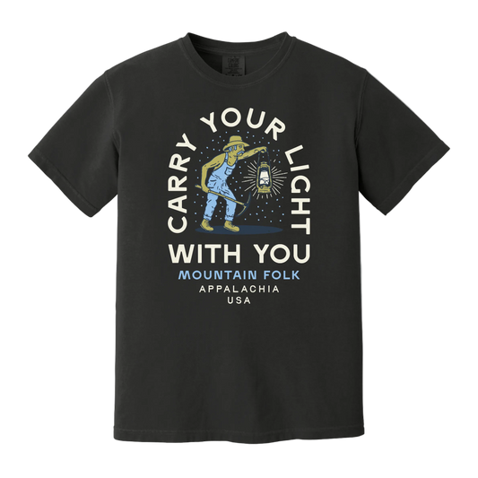 Black t-shirt with graphic text 'Carry Your Light With You' and an illustration of a miner holding a lantern.