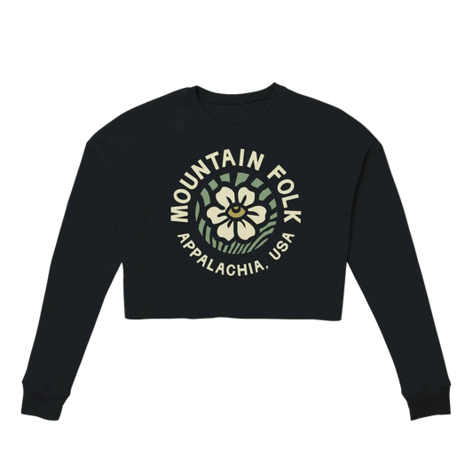 A black cropped sweatshirt with 'MOUNTAIN FOLK APPALACHIA USA' text and a floral design on the front.