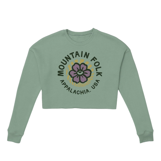 A women's cropped green sweatshirt with 'Mountain FOLK APPALACHIA, USA' text and a floral design on the front.