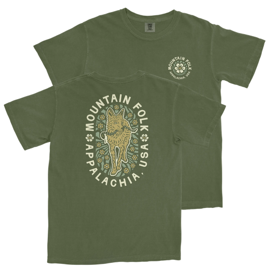 Green t-shirt with front and back three-color printing featuring an animal graphic and text 'MOUNTAIN FOLK'.