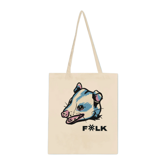 A beige tote bag with a graphic print of an opossum and the word 'FOLK' on it.