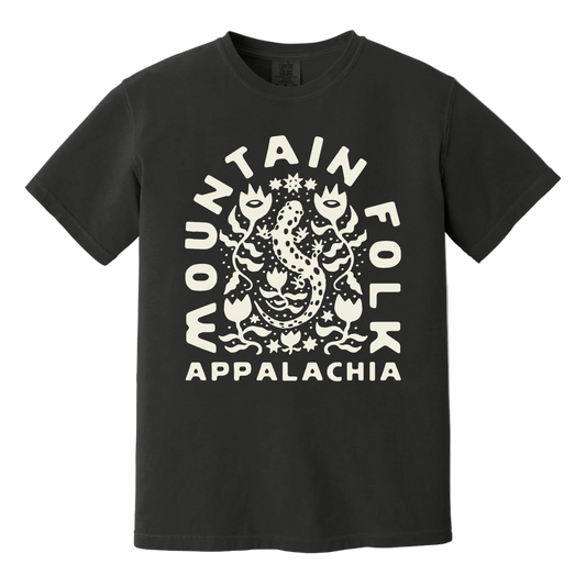 Black t-shirt with 'Mountain Folk Appalachia' text and a salamander design surrounded by wildflowers printed on the front.